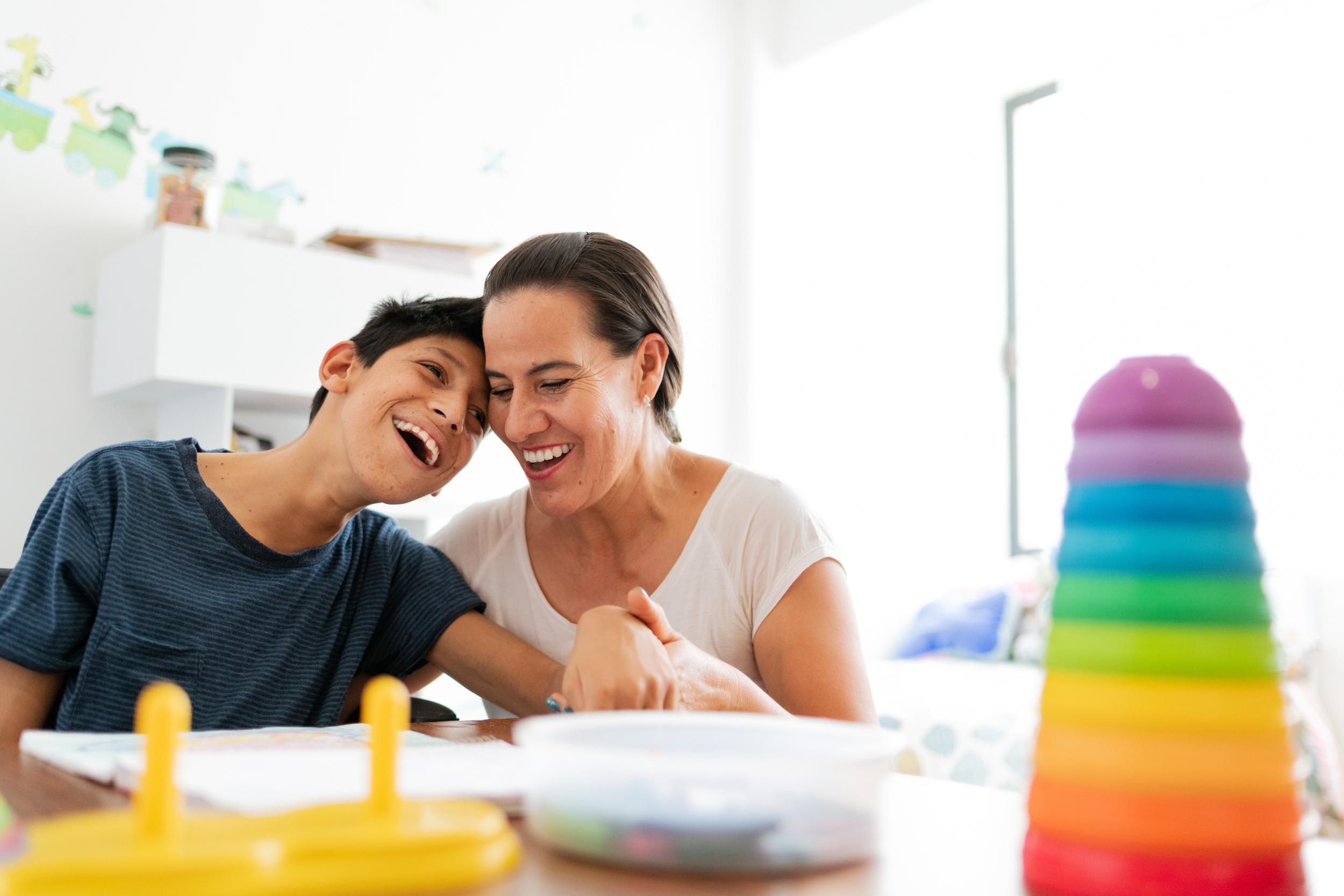 woman playing with boy with cerebral palsy